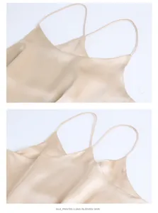 Detailed close-up of champagne silk camisole with thin straps and glossy texture