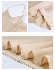 Detail of champagne silk camisole showing shoulder straps and premium glossy fabric texture