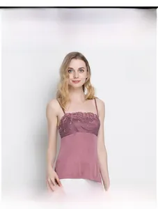 Close-up of fuchsia silk camisole with delicate floral lace embroidery and slim straps