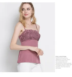 Close-up of fine floral lace embroidery on a dusty pink silk knit camisole top