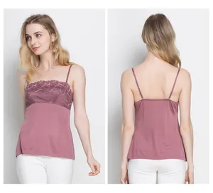 Detailed close-up of rose silk camisole featuring floral lace embroidery and adjustable straps