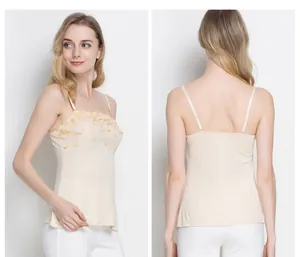 Detail of beige silk camisole with golden floral embroidery and adjustable thin straps