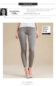Detail view of silver gray silk knit leggings on a tall model showing smooth texture