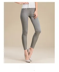 Detailed view of women's grey silk knit slim fit pants with glossy finish and elastic waist