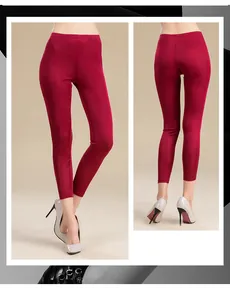 Close-up of wine red silk knit trousers with a slimming high-waisted fit and glossy finish