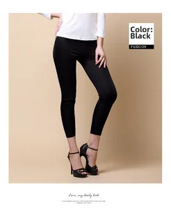 Detail of slim fit black silk knit ankle pants styled with high heel sandals