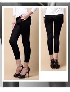 Front and back view of women's slim fit black silk knit leggings on model with heels