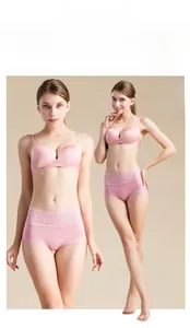 Detailed close-up of high-waist silk briefs featuring soft pink lace trim and bow accent