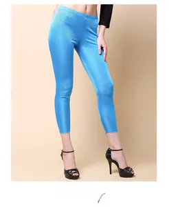 Detail of bright blue silk knit cropped trousers with a high-gloss finish and slim fit