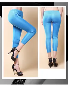 Close-up of bright blue silk knit cropped pants with slim fit and elastic glossy fabric
