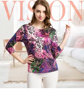 Close-up of vibrant leopard floral print on luxury silk t-shirt with knit texture