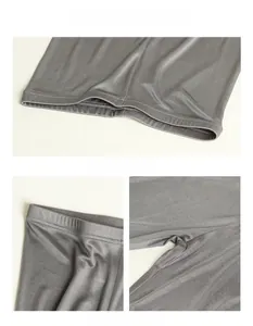 Detailed view of dark grey silk knit pants showing waist stitching and hem craftsmanship