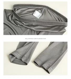 Detail view of M size wash label and smooth stitching on a grey silk knitted top