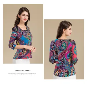 Detail view of ethnic paisley print on silk knit top with round neck and 3/4 sleeves