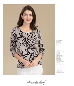 Detailed view of taupe silk knit top featuring black abstract swirl print patterns