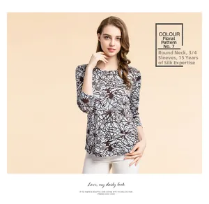 Detail of silk t-shirt featuring elegant floral print and comfortable crew neck design