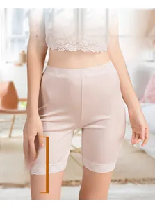 Detail of silk safety shorts with delicate lace trim for women in nude beige color