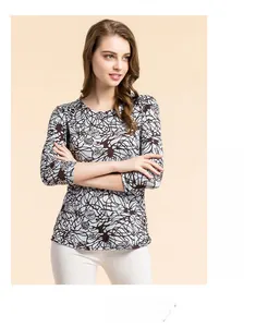 Detail shot of the abstract floral print and smooth texture on a silk blend t-shirt