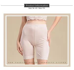 Close-up of pink silk safety shorts featuring delicate floral lace trim and smooth fabric
