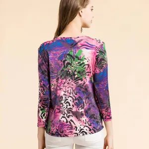 Women's silk knit t-shirt featuring vibrant multi-color abstract floral print and round neck
