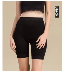 Close-up of elegant lace hem detailing on black silk knit safety shorts for women