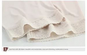 Detailed close-up of premium silk fabric with elegant lace floral hem on pink shorts