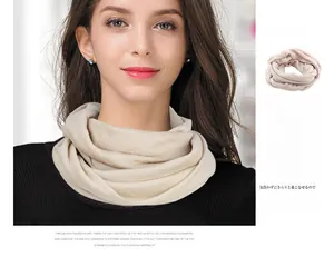 Detail of premium beige knit wool blend neck warmer showing soft texture and sheen