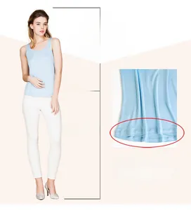 Detail view of light blue silk tank top with H-line cut and asymmetric high-low hem design