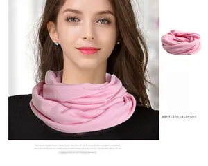 Detail of light pink pure wool snood showing soft knitted texture and elegant double loop drape