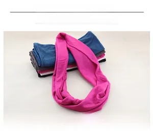 Detail view of multicolored knitted pure wool infinity scarves in various vibrant colors