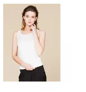Detail shot of a white silk tank top showing the premium knit texture and slim fit design