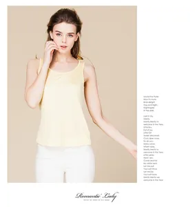 Close-up of silk knit tank top in light yellow showing soft texture and round neck detail