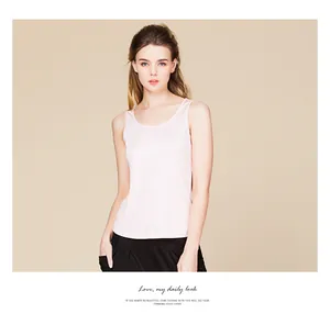 Detail view of pink silk knitted tank top showing slim fit cut and elegant crew neck