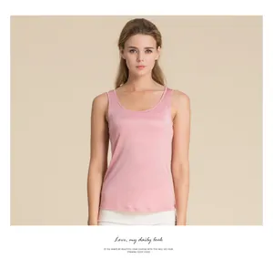 Detail shot of a slim fit light pink silk tank top featuring a smooth glossy texture