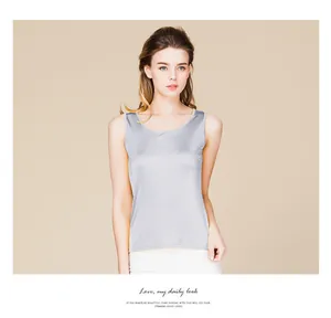 Detail of silver silk tank top showing smooth satin texture and refined slim fit design