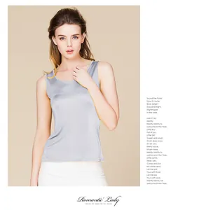 Close-up detail of silver silk tank top showing elegant smooth satin texture and pearl luster