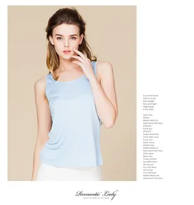 Light blue slim silk tank top with round neck shown in a fashion editorial photo layout
