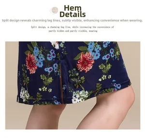 Detail view of the silk dress side slit hem with red and blue floral print on navy fabric