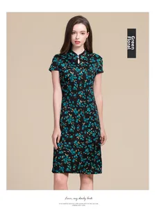 Detail of green floral print on black silk qipao dress with drop hollow neckline
