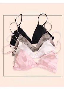 Detailed view of four seamless silk triangle bras in pink, white, champagne and black