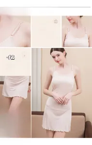 Detail of adjustable straps and ruffle hem on silk slip dress in apricot