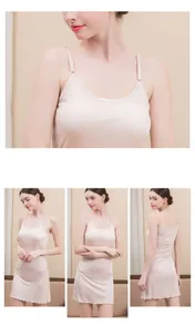 Detail of beige silk knit slip dress featuring adjustable straps and ruffled hem design