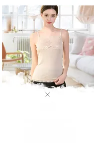 Detail shot of elegant beige silk camisole with delicate lace trim on the shoulder straps