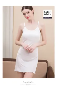 Detailed view of white silk camisole slip dress with delicate wavy hemline