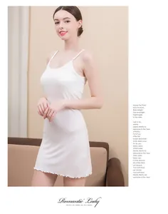 Detailed view of white silk sleepwear hem with delicate ruffled edges and fine stitching