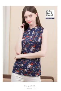 Detail of floral printed silk knit top showing sleeveless high neck cut in dark blue