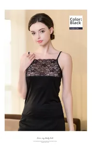 Detailed close-up of exquisite black floral lace trim on a luxury silk camisole top