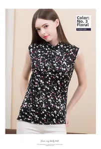 Detail of silk sleeveless top with white floral print on black fabric and high neckline