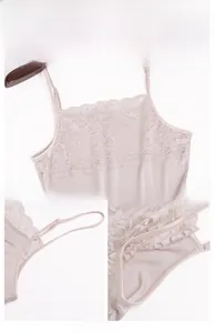 Detail view of lace neckline and adjustable thin straps on silk camisole top