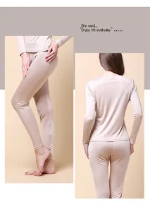 Detail of silk thermal underwear set with lace edges in champagne gold satin fabric